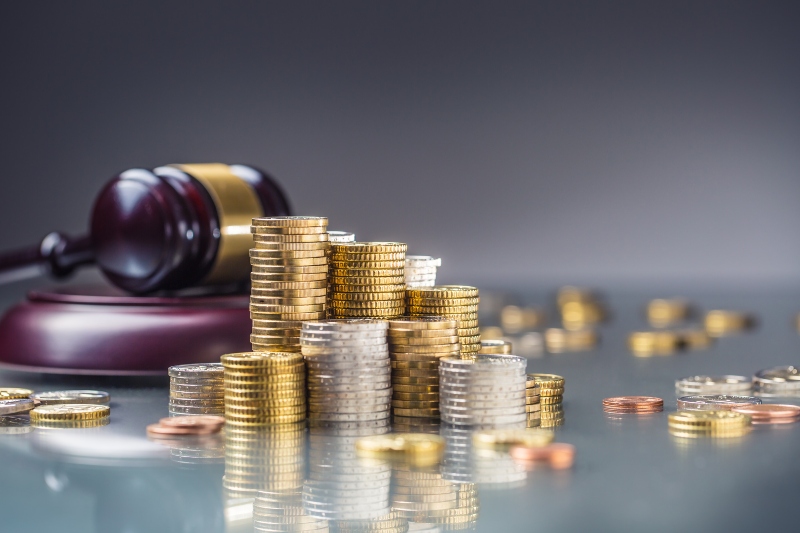 towers with euro coins and justice hammer in the background.