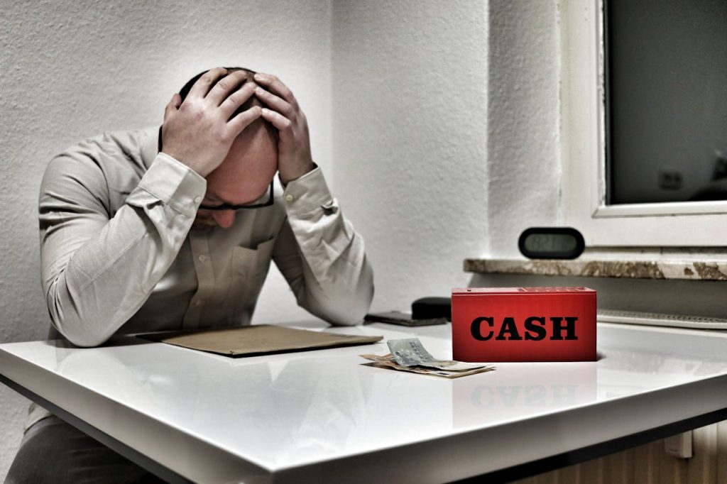 stressed-man-with-cash-box-in-office-setting-34981467